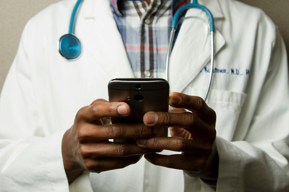 Illustrative photograph of a clinician holding a smartphone